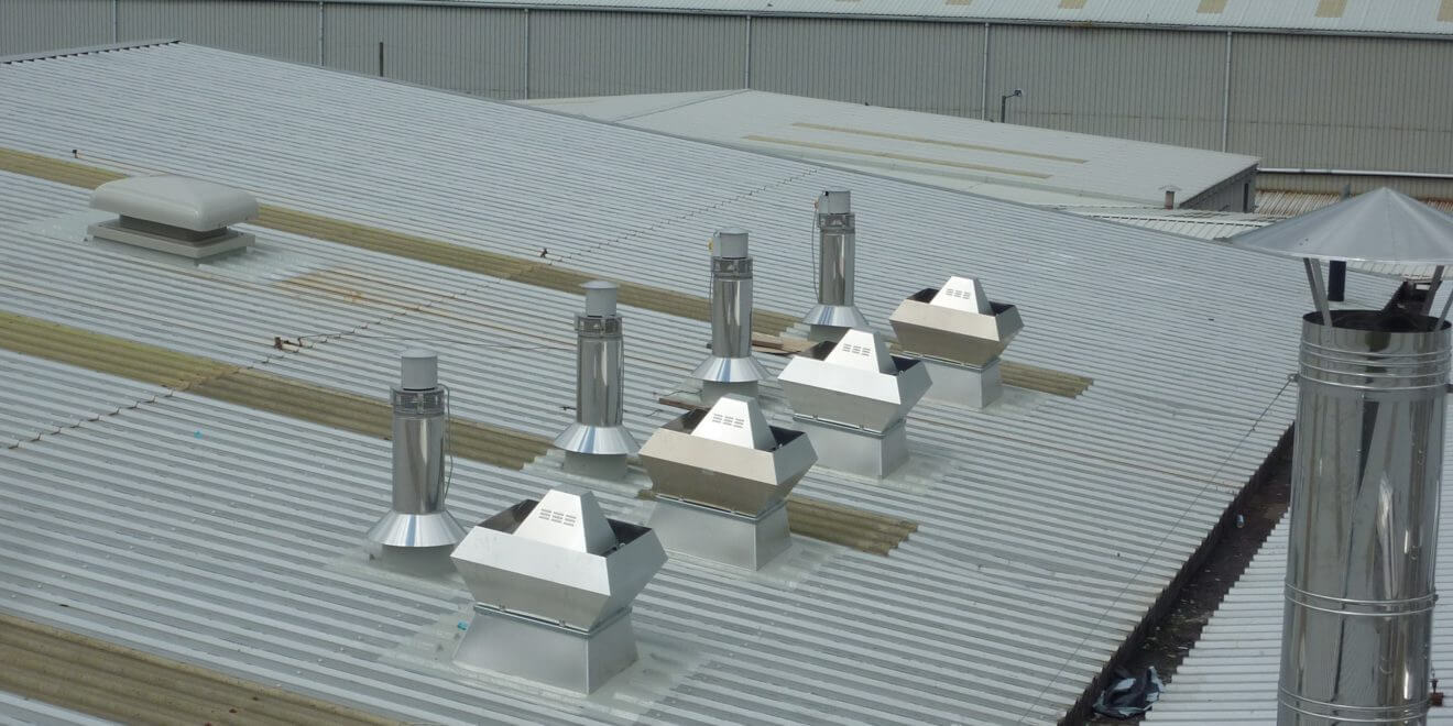 Roof penetrations and weathering systems installed on the top of a building