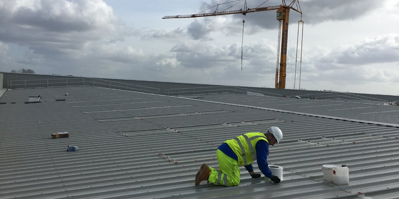 roof penetration being weatherproofed on a modular building